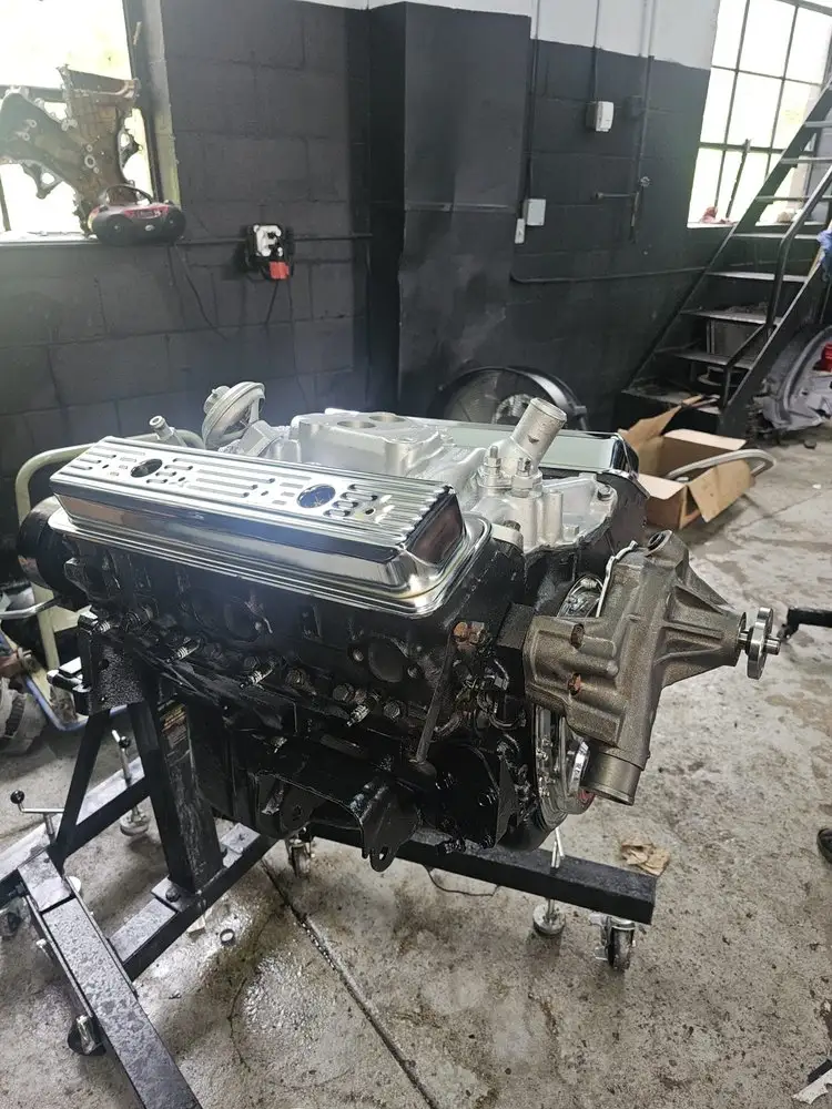 Rebuilt engine with new valve covers on a stand